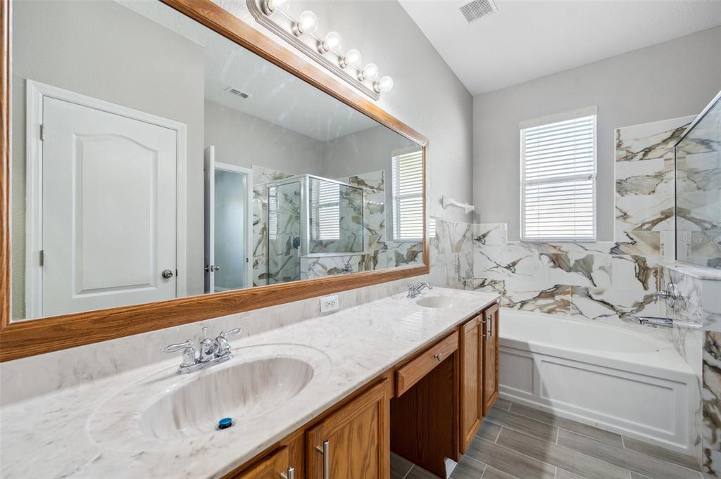 12351 Ridgedale Drive Hudson, FL 34669 - Photo 22 of 54 a bathroom with a sink double vanity and a bathtub