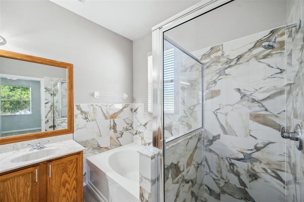 12351 Ridgedale Drive Hudson, FL 34669 - Photo 24 of 54 a bath room with a bath tub and a shower