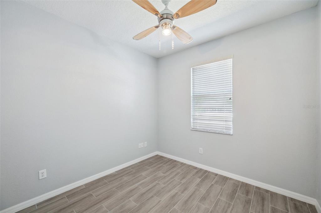 12351 Ridgedale Drive Hudson, FL 34669 - Photo 27 of 54 an empty room with a window and a fan