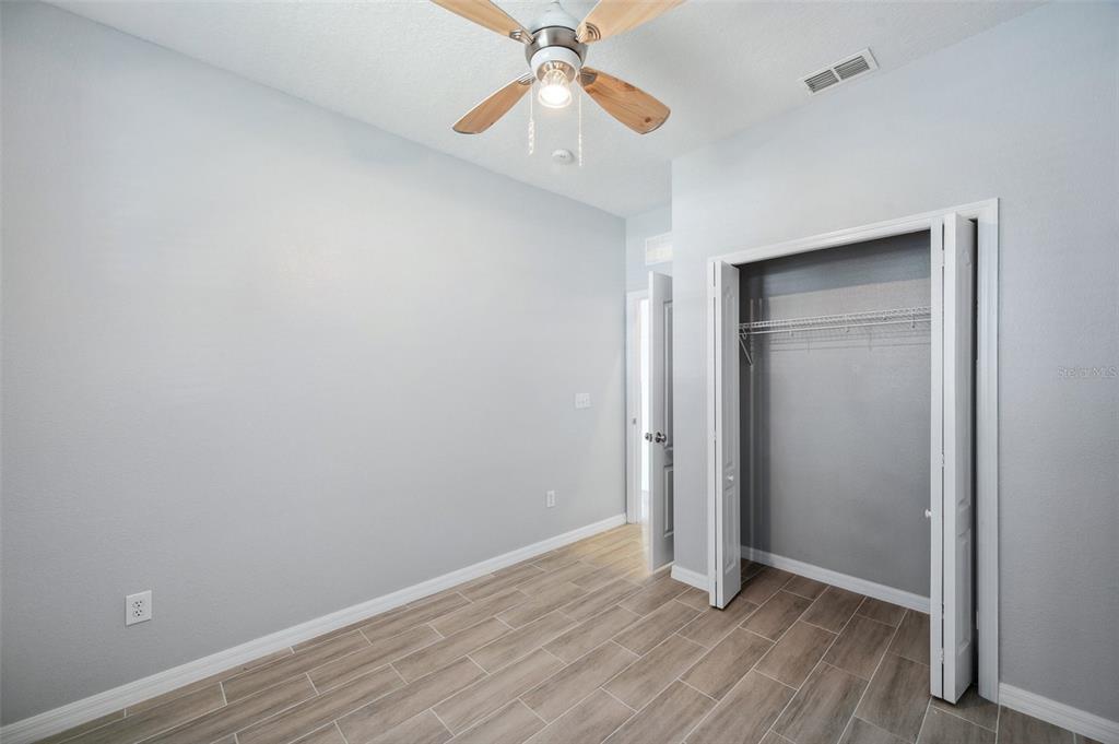 12351 Ridgedale Drive Hudson, FL 34669 - Photo 29 of 54 a view of an empty room with window and wooden floor