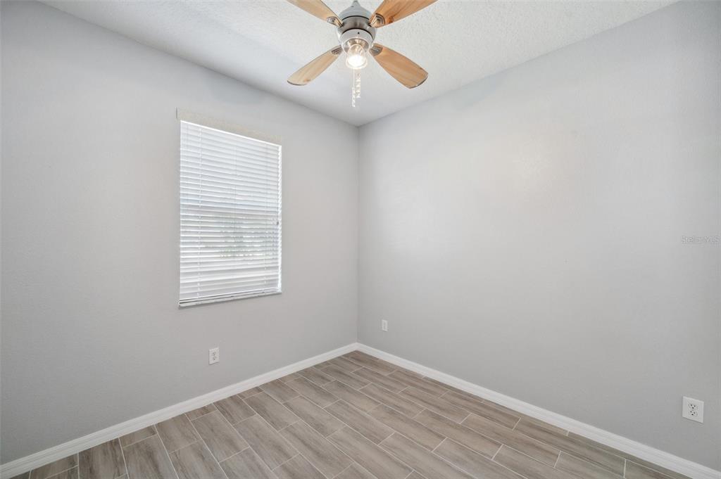 12351 Ridgedale Drive Hudson, FL 34669 - Photo 31 of 54 an empty room with a window and a fan
