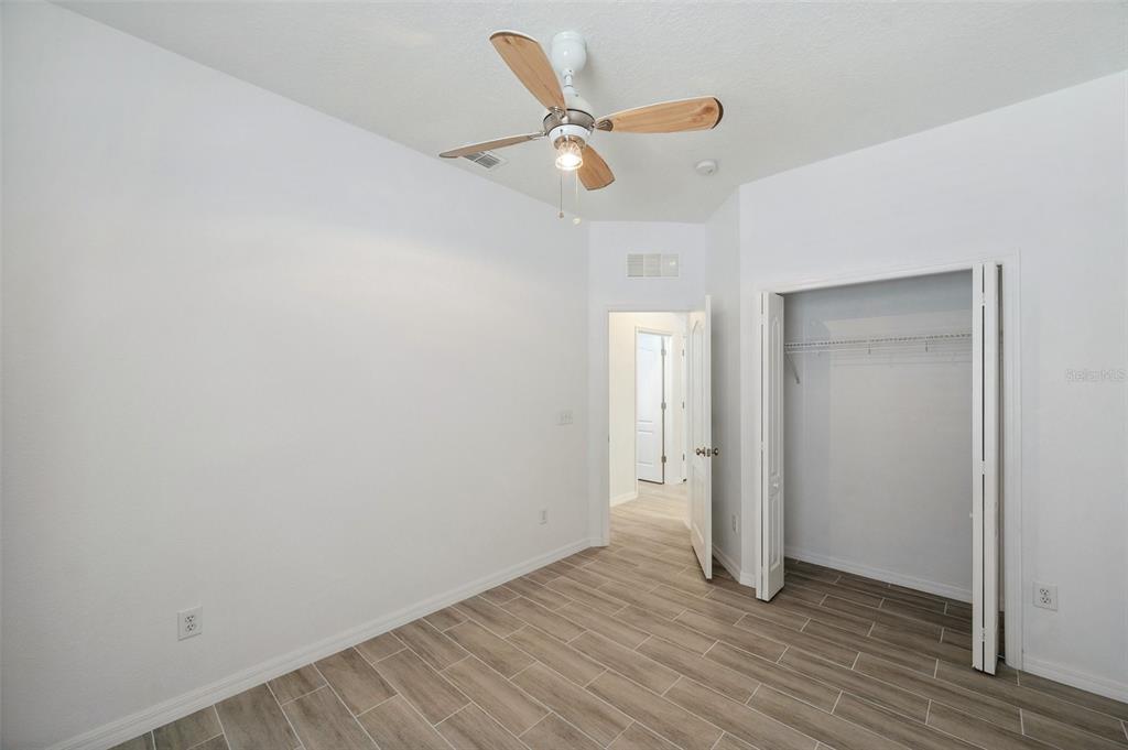 12351 Ridgedale Drive Hudson, FL 34669 - Photo 35 of 54 a view of an empty room with wooden floor