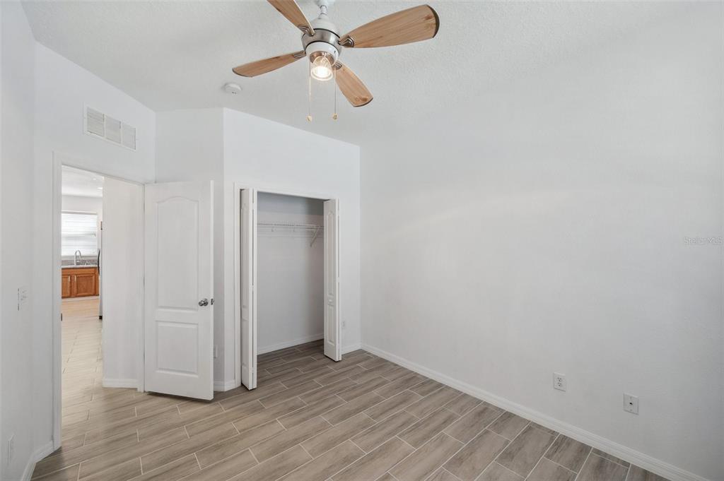 12351 Ridgedale Drive Hudson, FL 34669 - Photo 36 of 54 an empty room with wooden floor a ceiling fan and closet