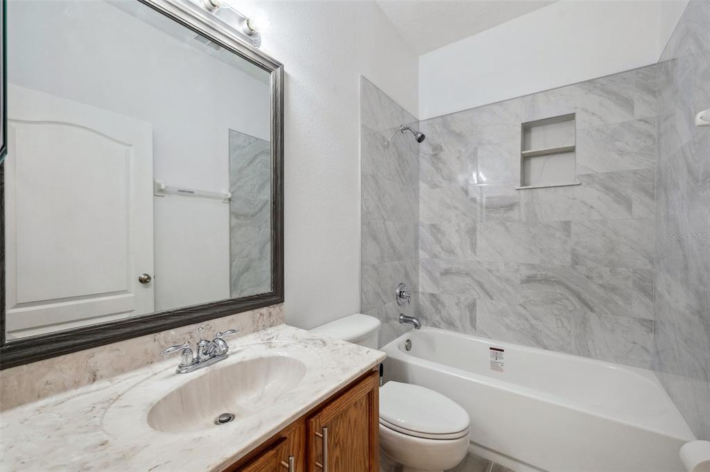 12351 Ridgedale Drive Hudson, FL 34669 - Photo 37 of 54 a bathroom with a sink mirror toilet and bathtub