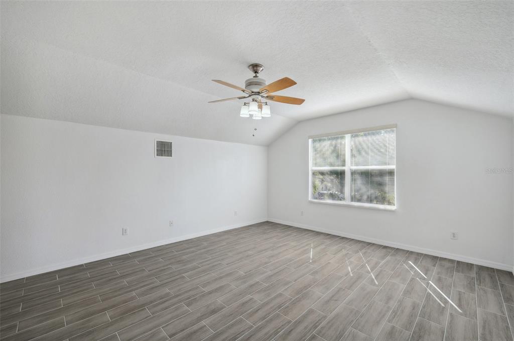 12351 Ridgedale Drive Hudson, FL 34669 - Photo 40 of 54 wooden floor in an empty room with a window