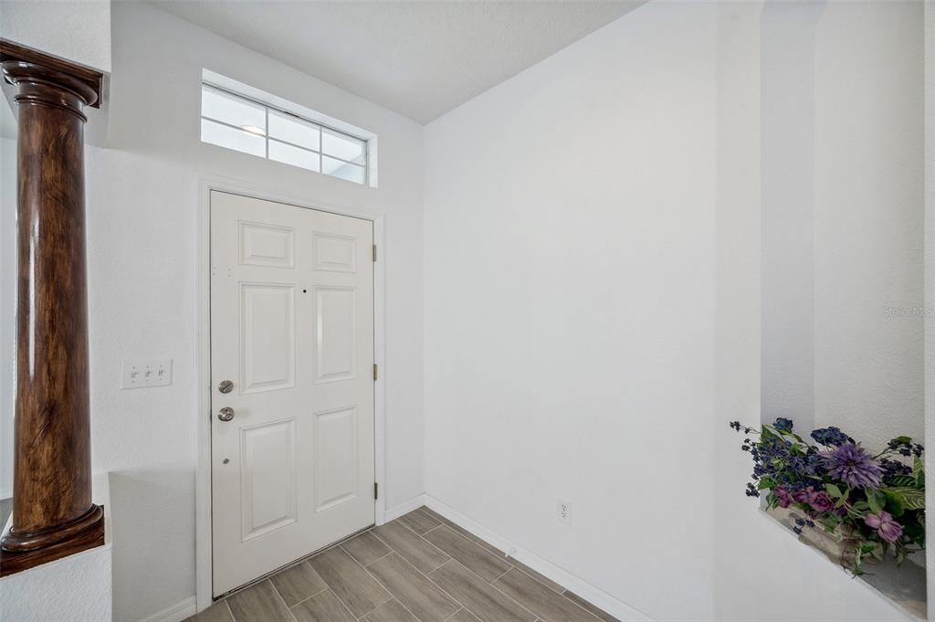 12351 Ridgedale Drive Hudson, FL 34669 - Photo 4 of 54 a view of a hallway with wooden floor