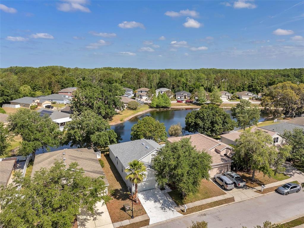 12351 Ridgedale Drive Hudson, FL 34669 - Photo 49 of 54 an aerial view of a house with a yard and lake view
