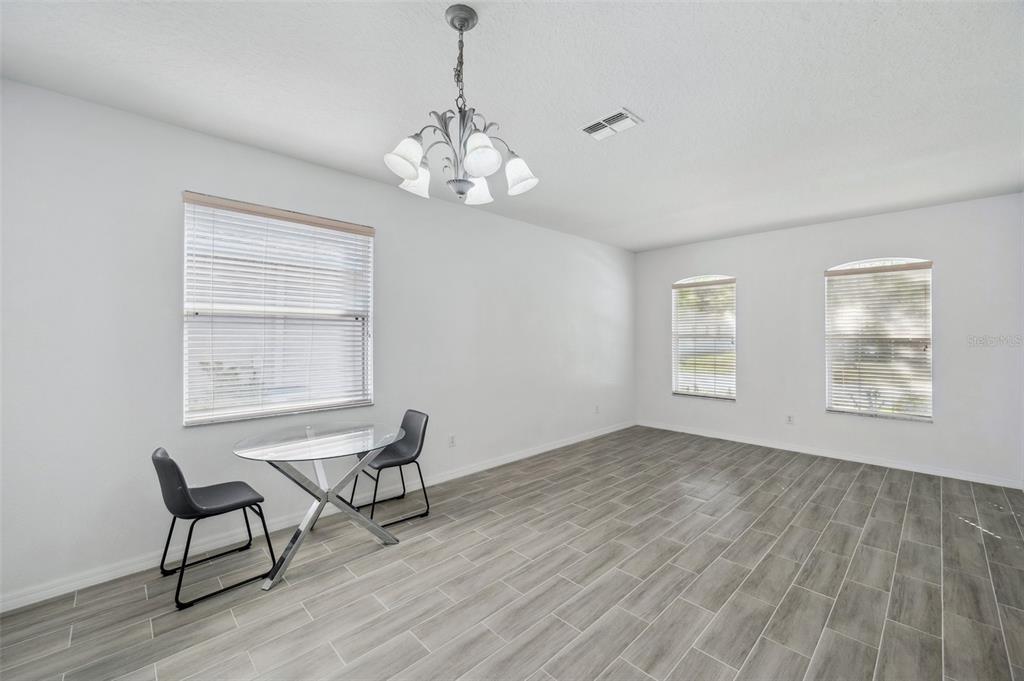 12351 Ridgedale Drive Hudson, FL 34669 - Photo 5 of 54 a view of a room with wooden floor lounge chair and windows
