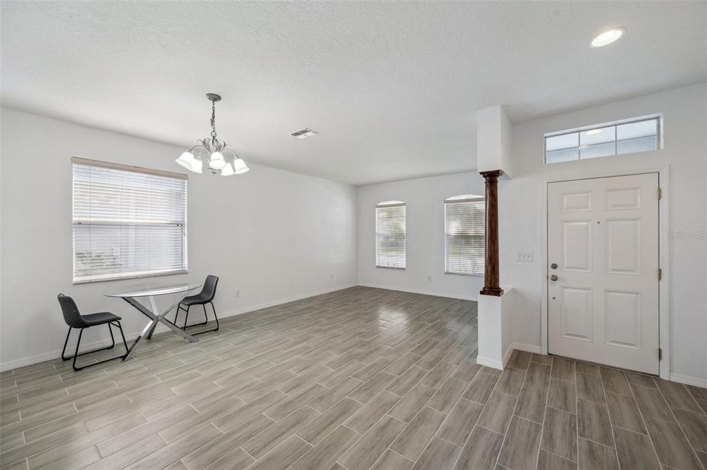 12351 Ridgedale Drive Hudson, FL 34669 - Photo 7 of 54 an empty room with wooden floor mirror and windows