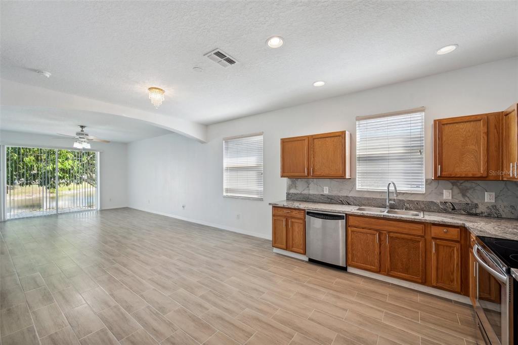 12351 Ridgedale Drive Hudson, FL 34669 - Photo 10 of 54 a kitchen with granite countertop a sink and cabinets