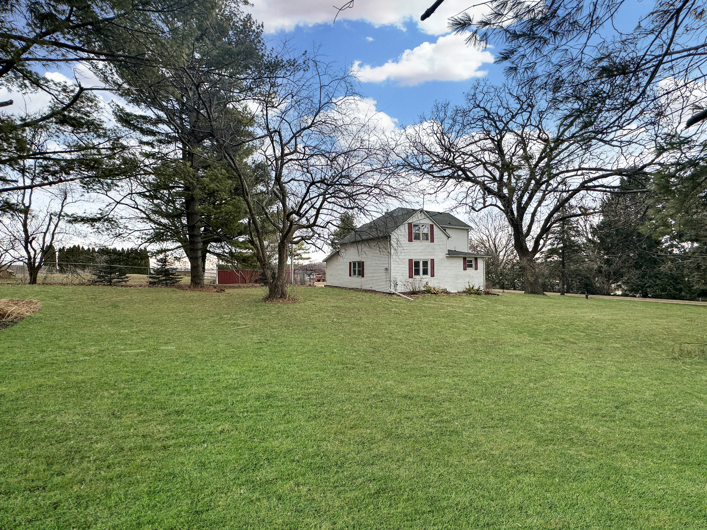 2289 North AYP Road Freeport, IL 61032 - Photo 1 of 52 a view of white house with a big yard and large trees