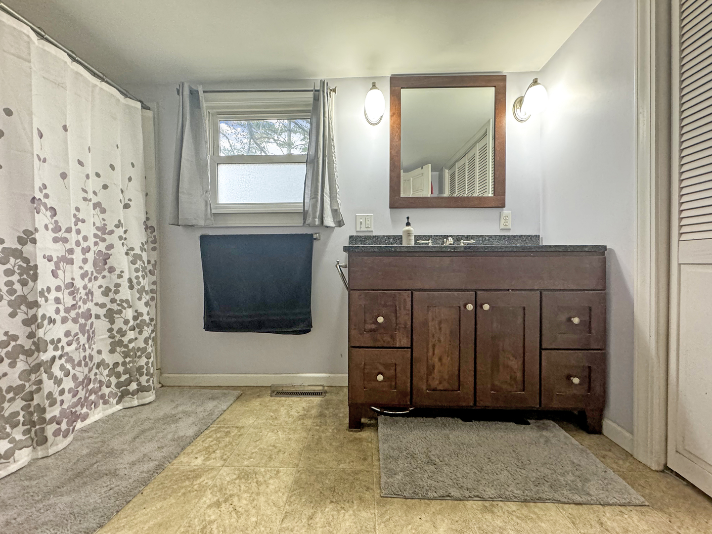 2289 North AYP Road Freeport, IL 61032 - Photo 28 of 52 a bathroom with a granite countertop sink a mirror and a shower