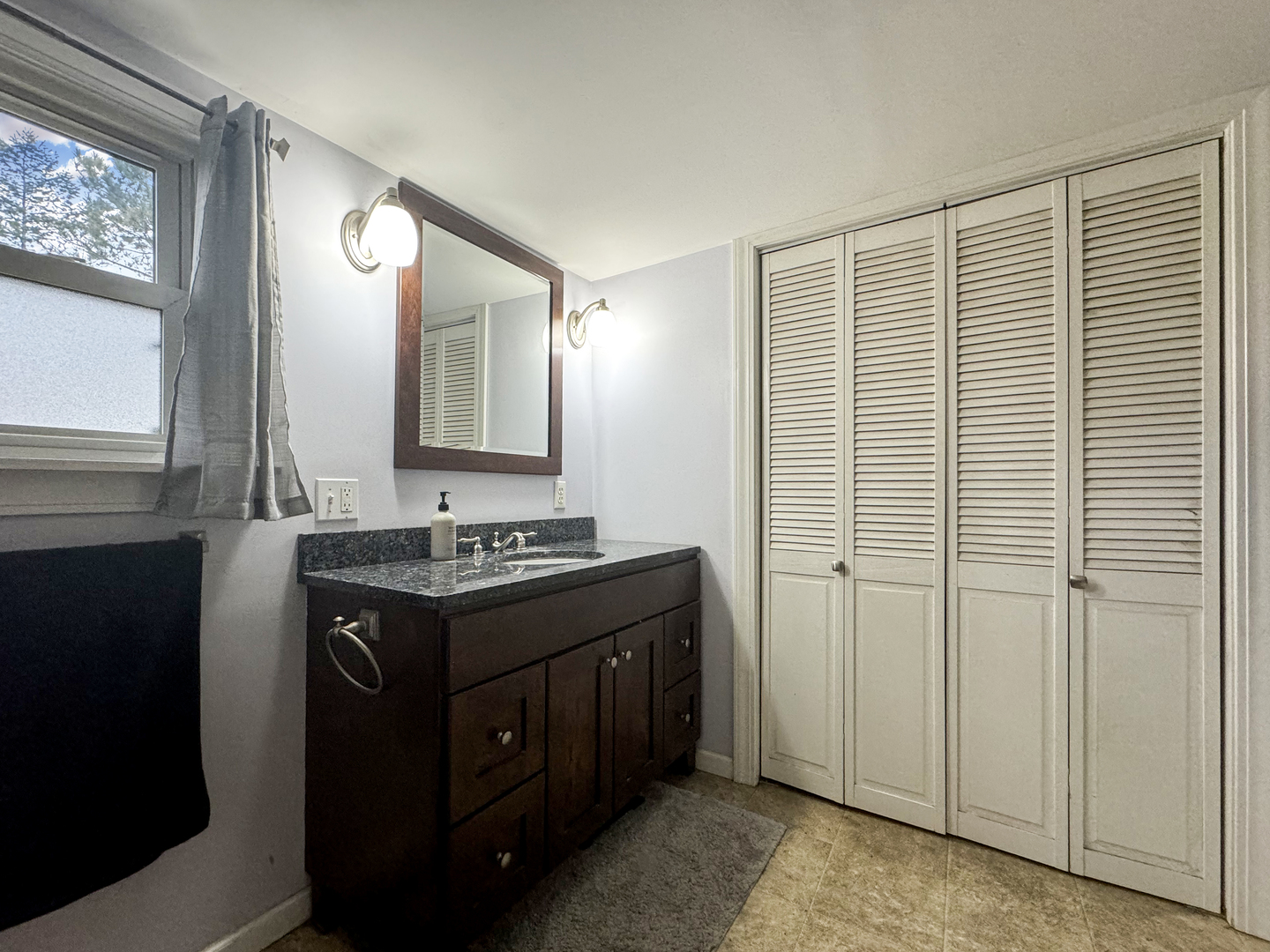 2289 North AYP Road Freeport, IL 61032 - Photo 29 of 52 a bathroom with a sink a mirror and a shower