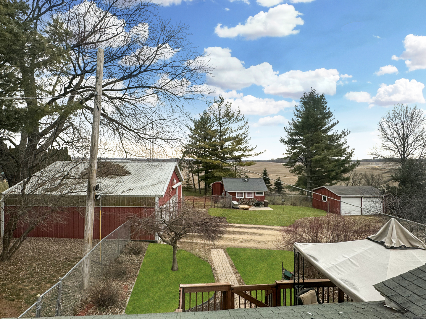 2289 North AYP Road Freeport, IL 61032 - Photo 5 of 52 a view of an house with backyard outdoor seating and trees in the background