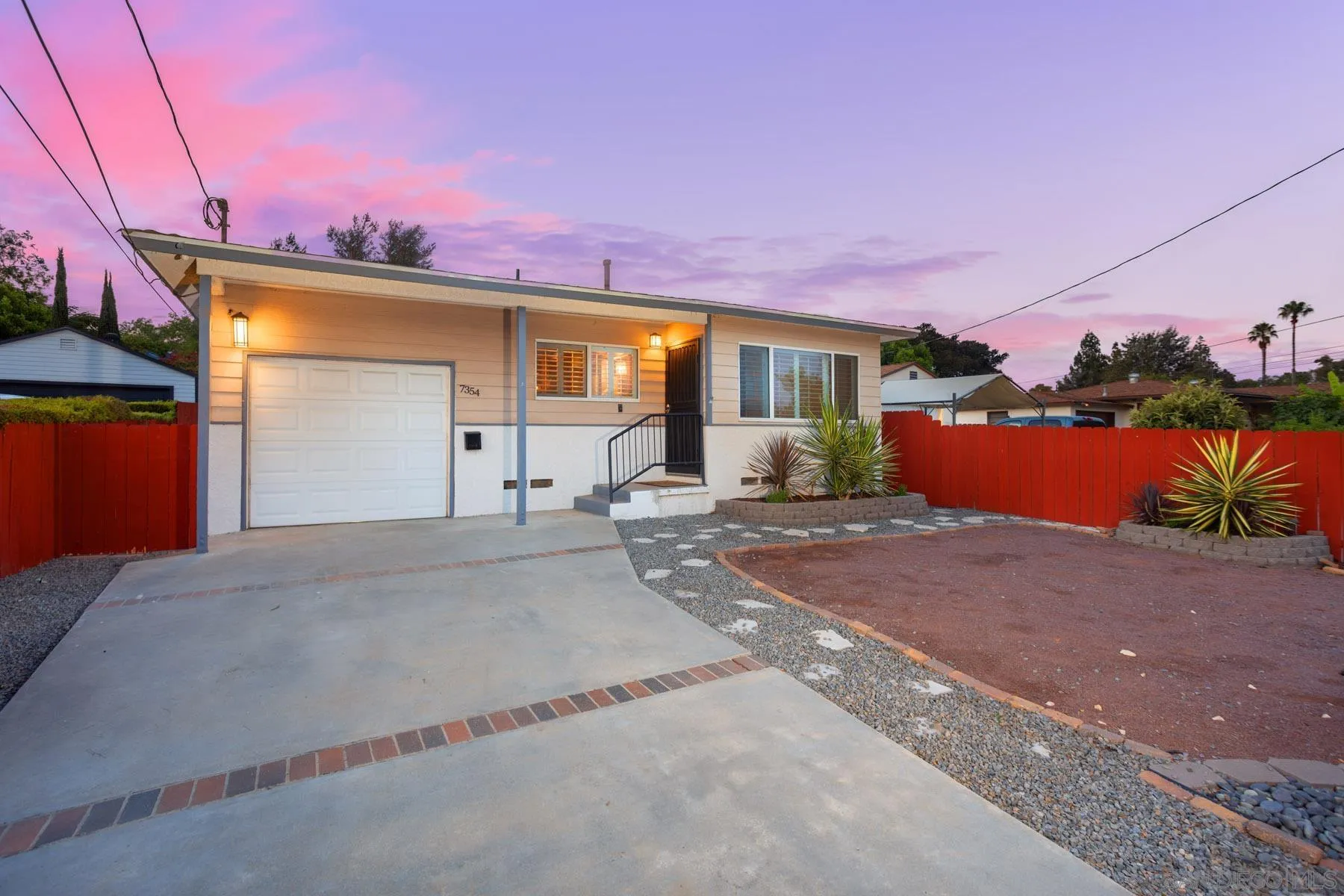 7354 Colony Road La Mesa, CA 91942 - Photo 1 of 24 a front view of a house with a yard and garage