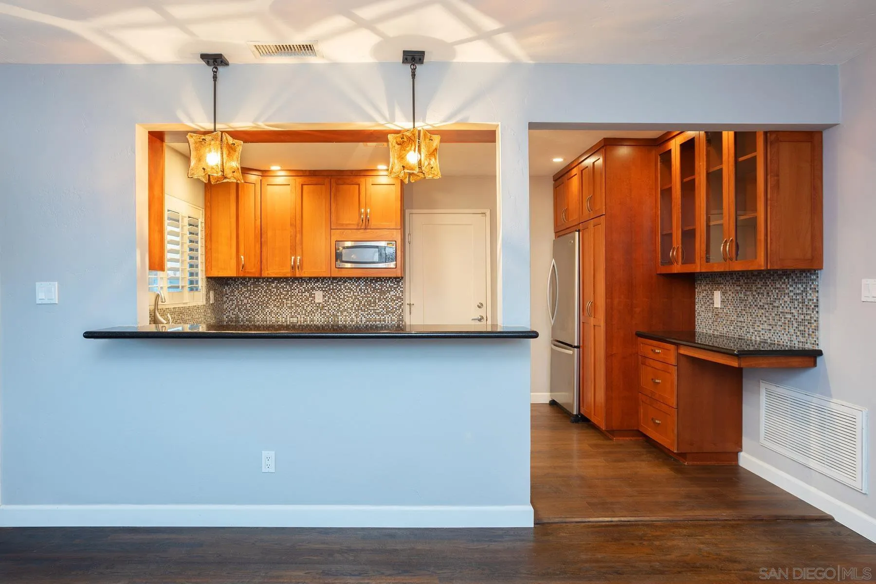 7354 Colony Road La Mesa, CA 91942 - Photo 11 of 24 a view of kitchen with granite countertop cabinets and wooden floor