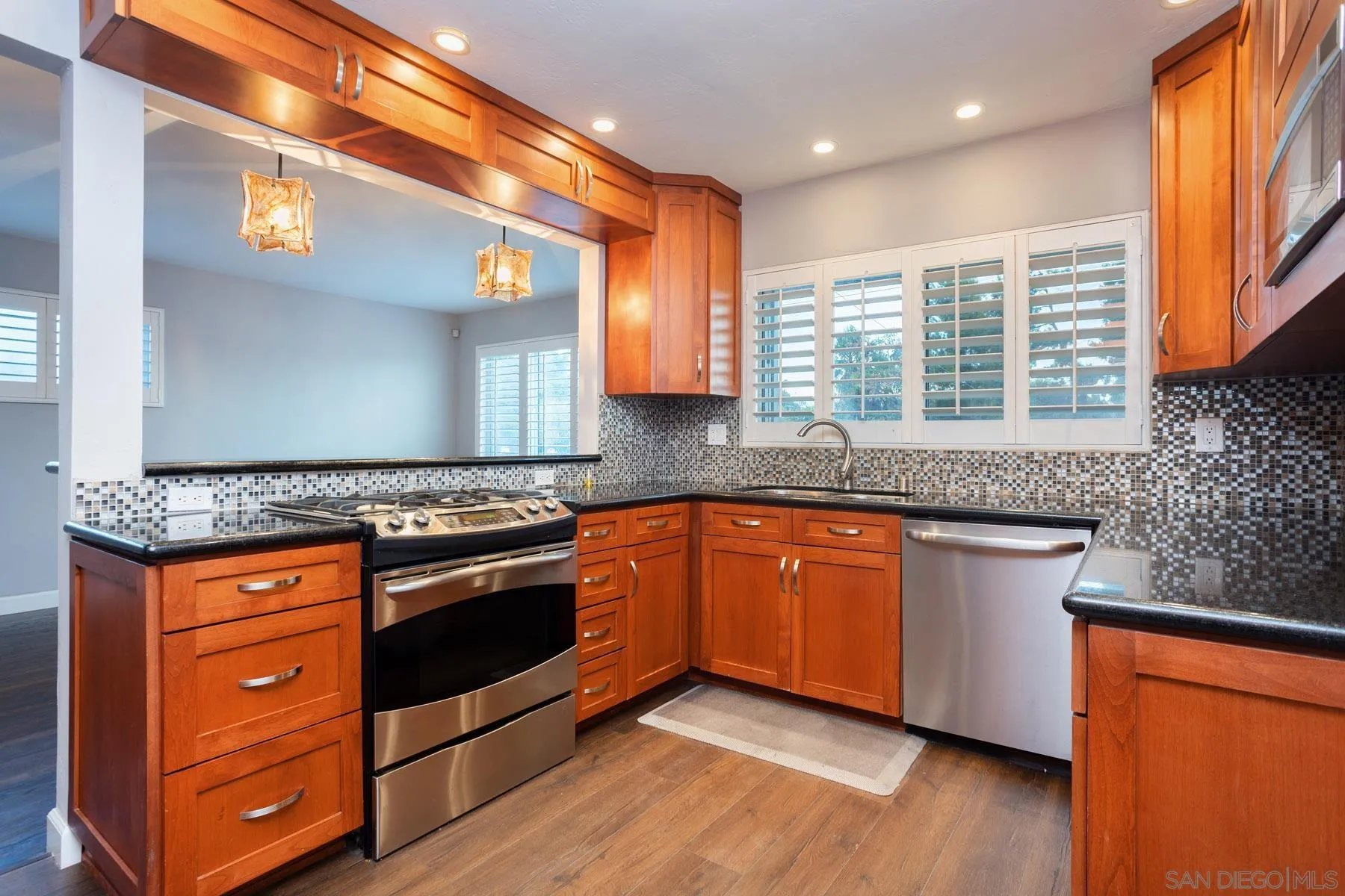 7354 Colony Road La Mesa, CA 91942 - Photo 13 of 24 a kitchen with stainless steel appliances granite countertop a stove a sink and a microwave