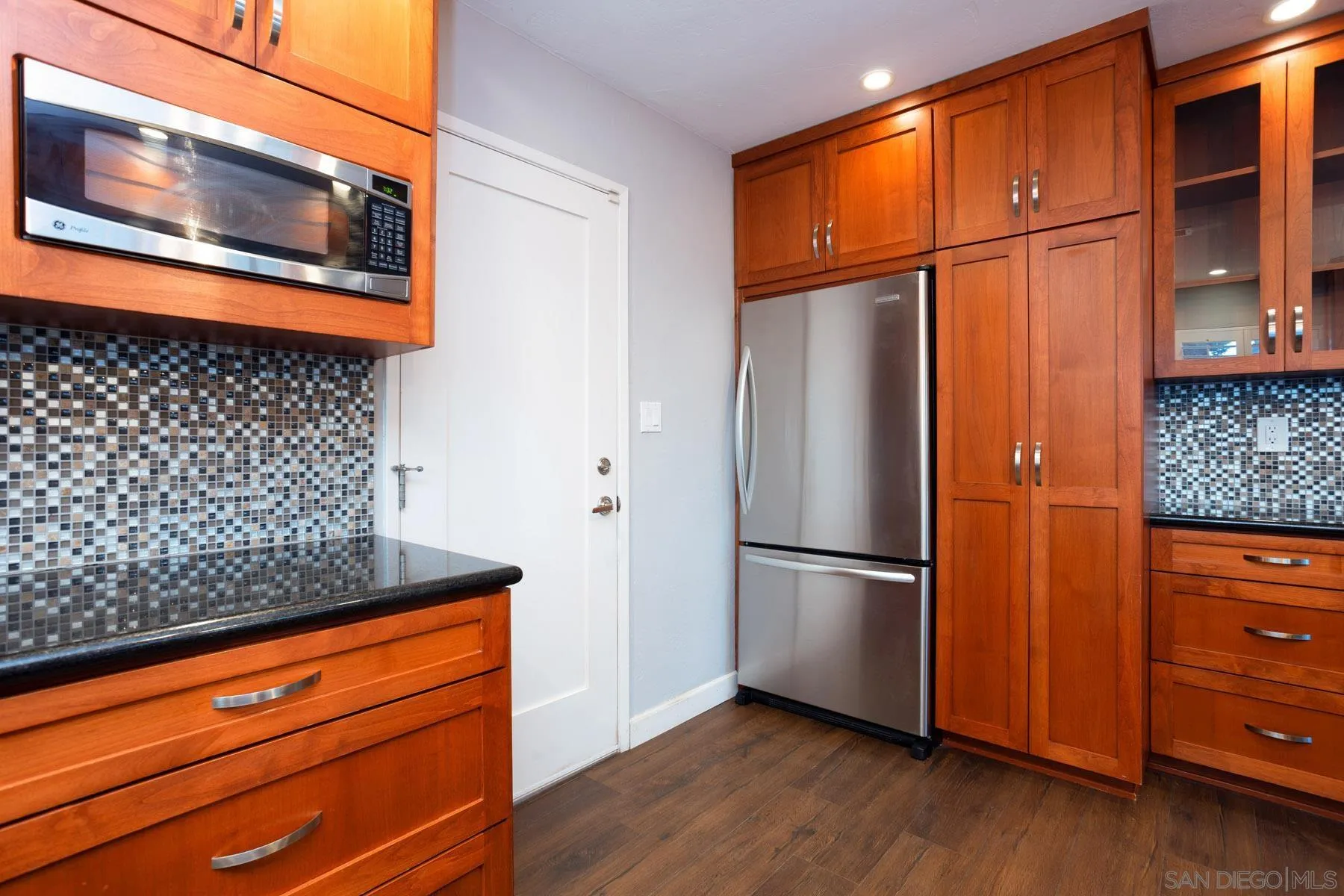 7354 Colony Road La Mesa, CA 91942 - Photo 14 of 24 a kitchen with stainless steel appliances granite countertop a refrigerator and a wooden floor