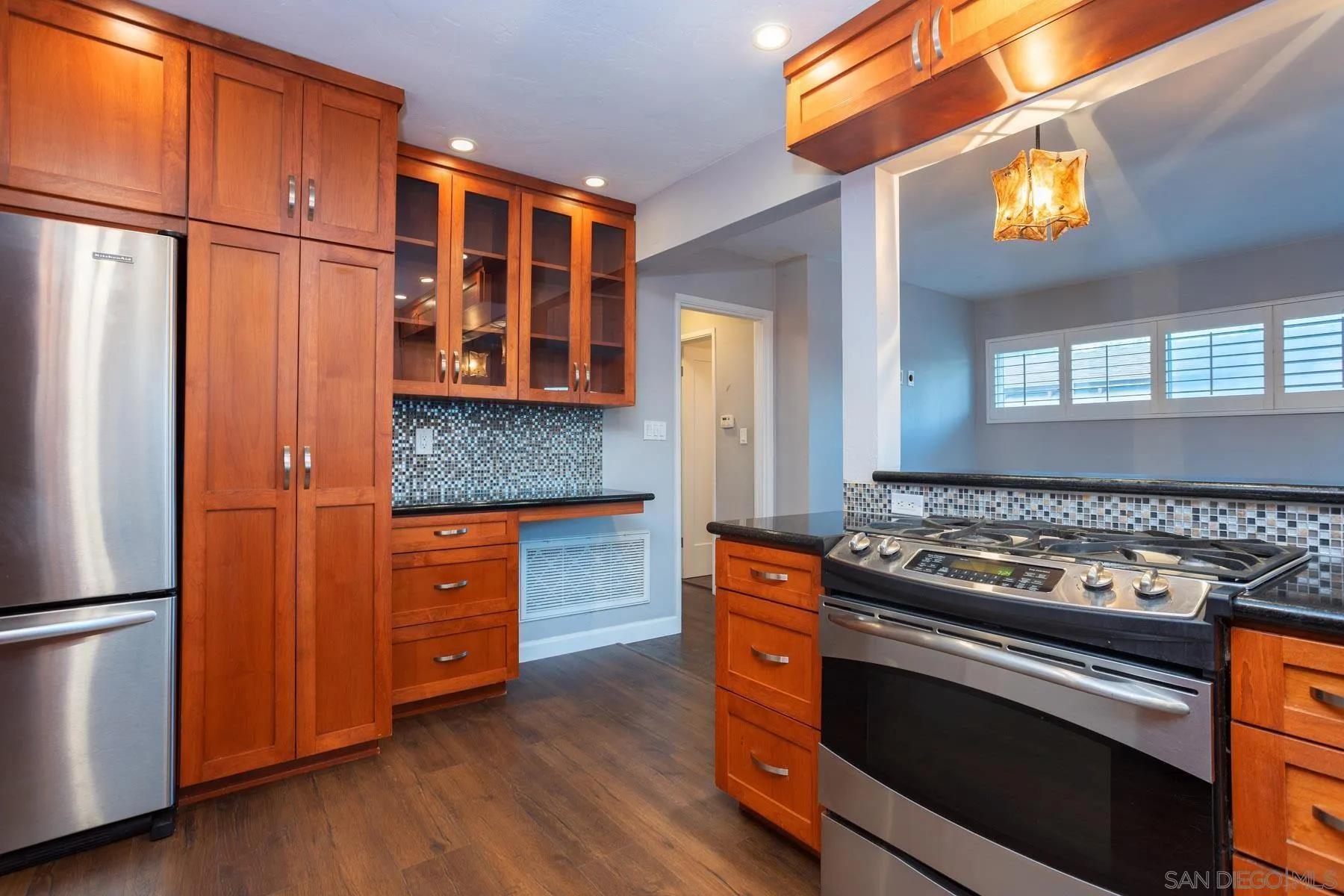 7354 Colony Road La Mesa, CA 91942 - Photo 15 of 24 a kitchen with stainless steel appliances granite countertop a stove and a refrigerator