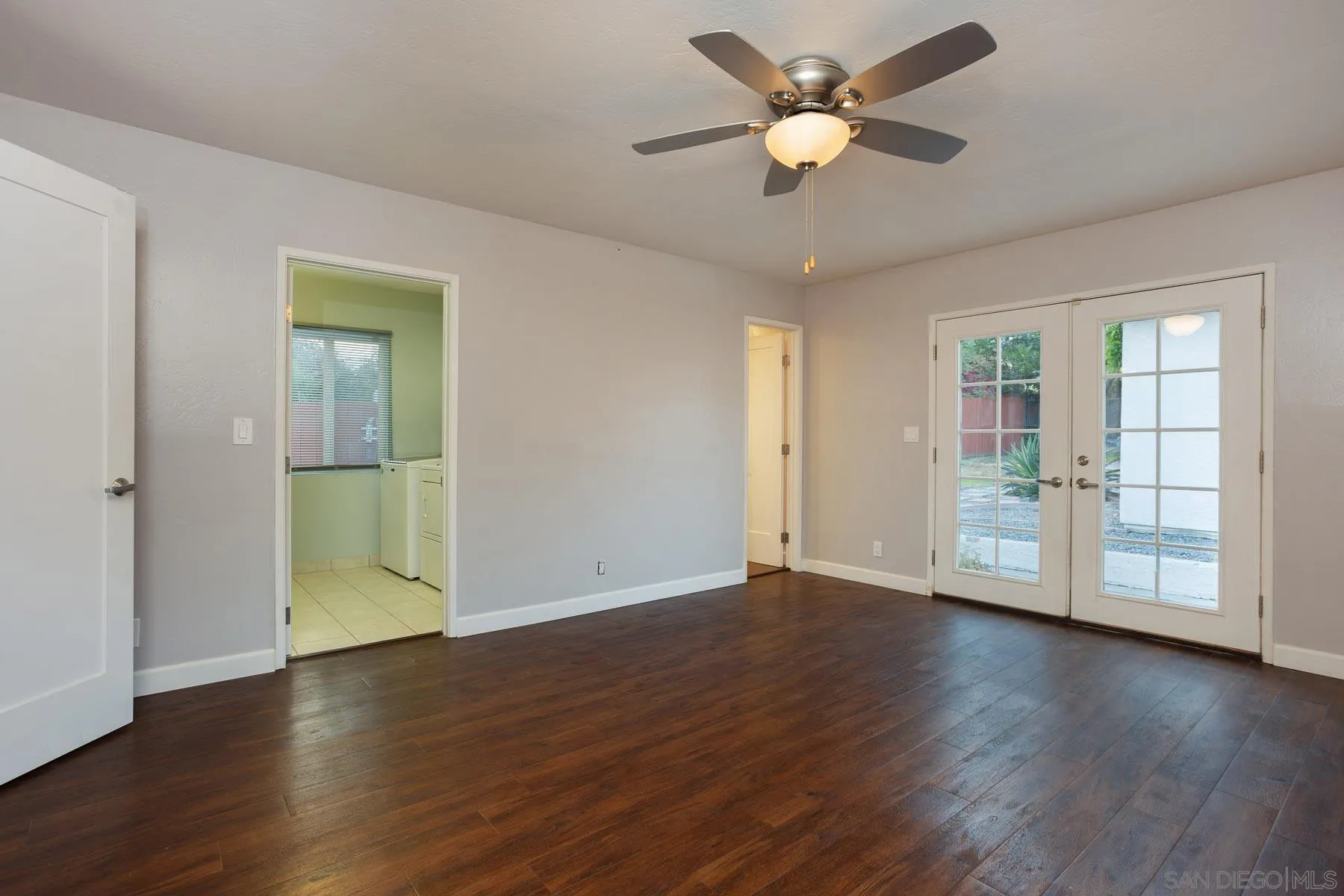 7354 Colony Road La Mesa, CA 91942 - Photo 16 of 24 a view of an empty room with wooden floor and a ceiling fan