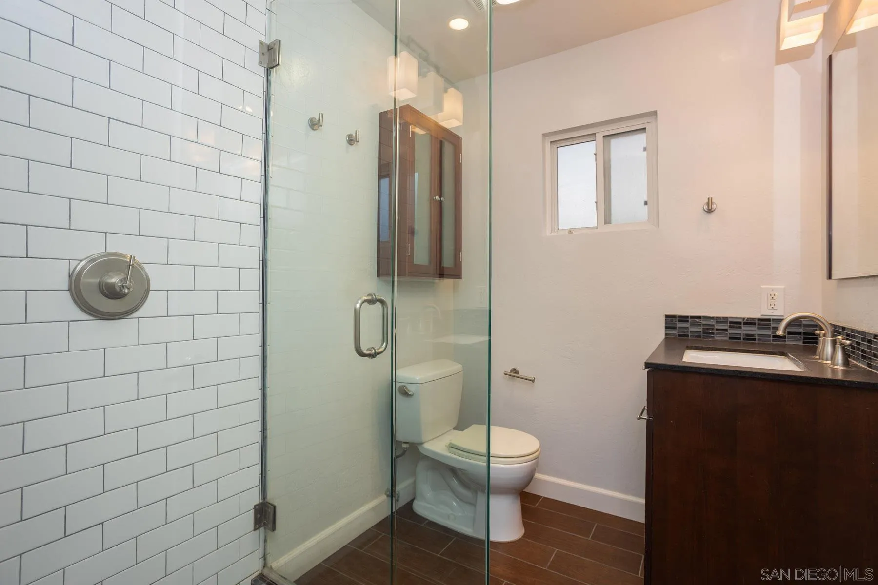 7354 Colony Road La Mesa, CA 91942 - Photo 18 of 24 a bathroom with a toilet a sink and shower