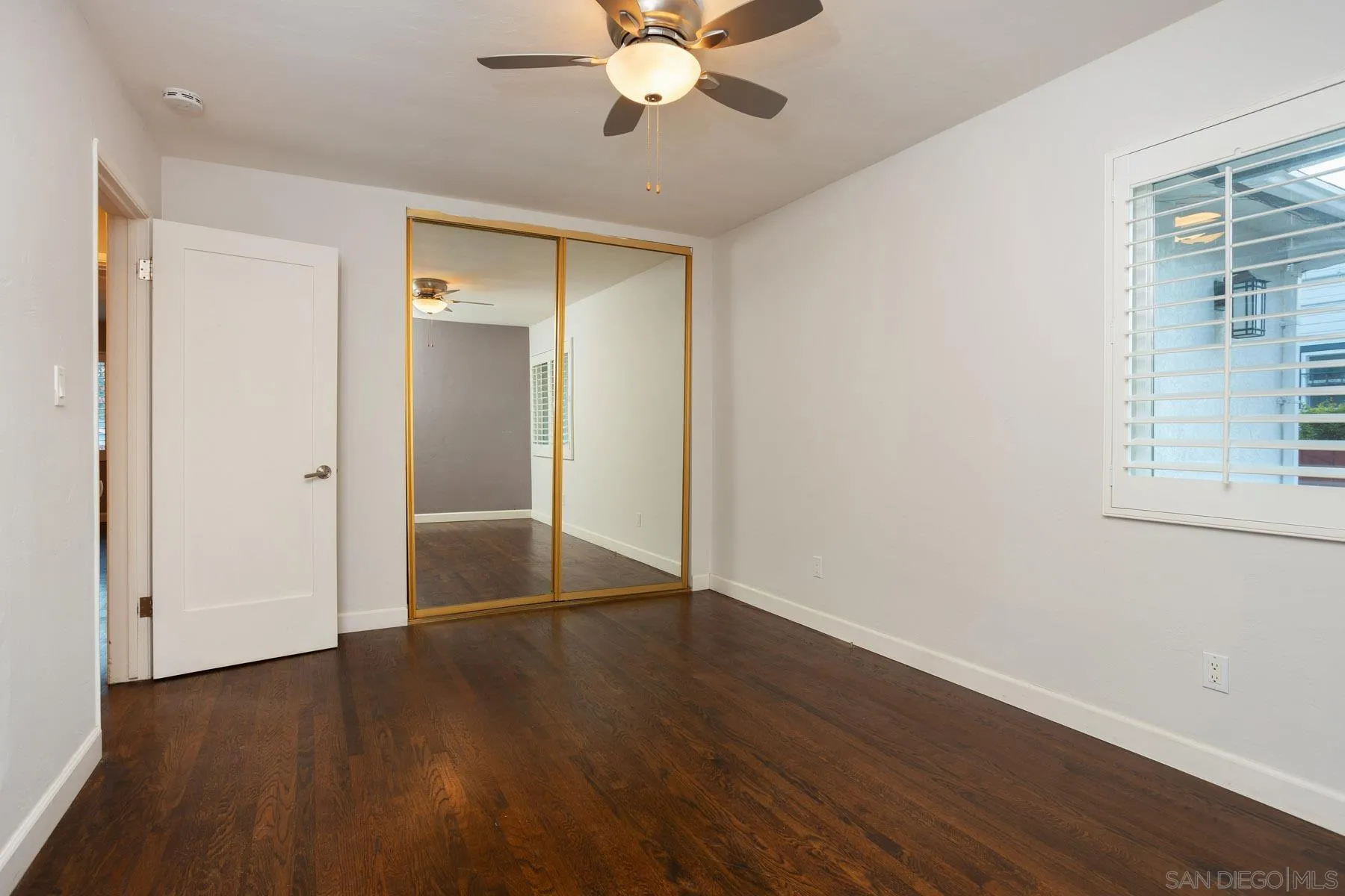7354 Colony Road La Mesa, CA 91942 - Photo 20 of 24 a view of an empty room with wooden floor and a window