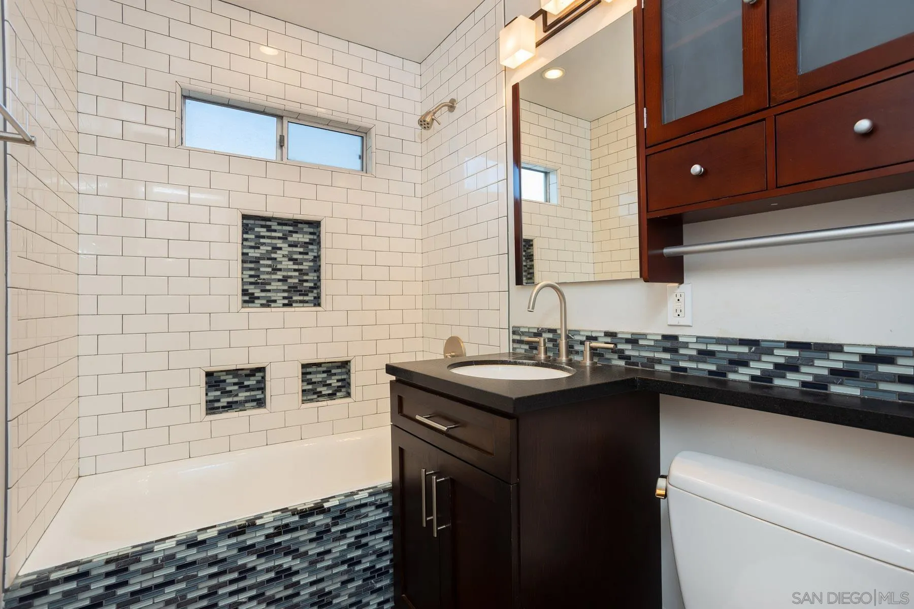 7354 Colony Road La Mesa, CA 91942 - Photo 21 of 24 a bathroom with a sink a vanity and a mirror