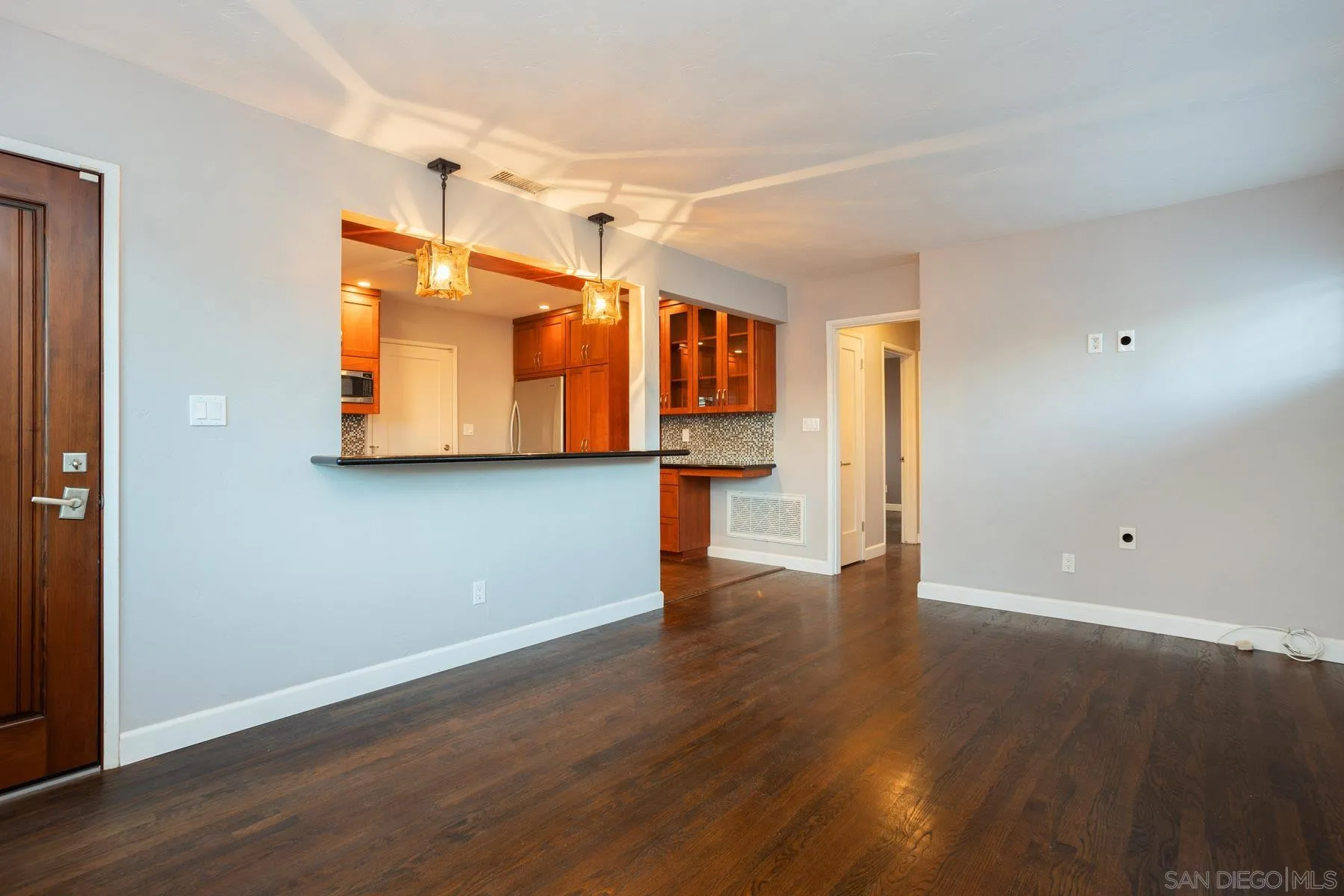 7354 Colony Road La Mesa, CA 91942 - Photo 7 of 24 a view of a kitchen with a fridge and wooden floor