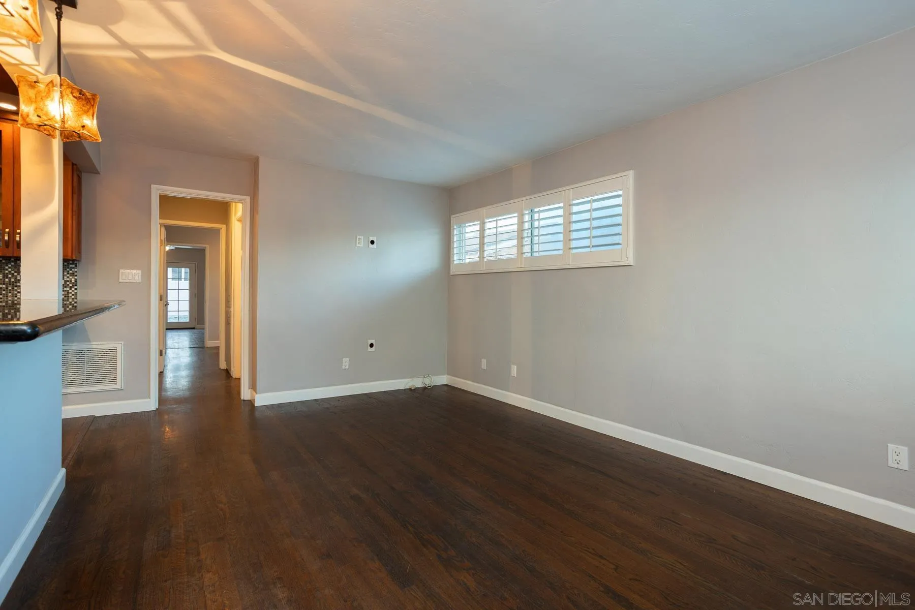7354 Colony Road La Mesa, CA 91942 - Photo 8 of 24 an empty room with wooden floor and a window