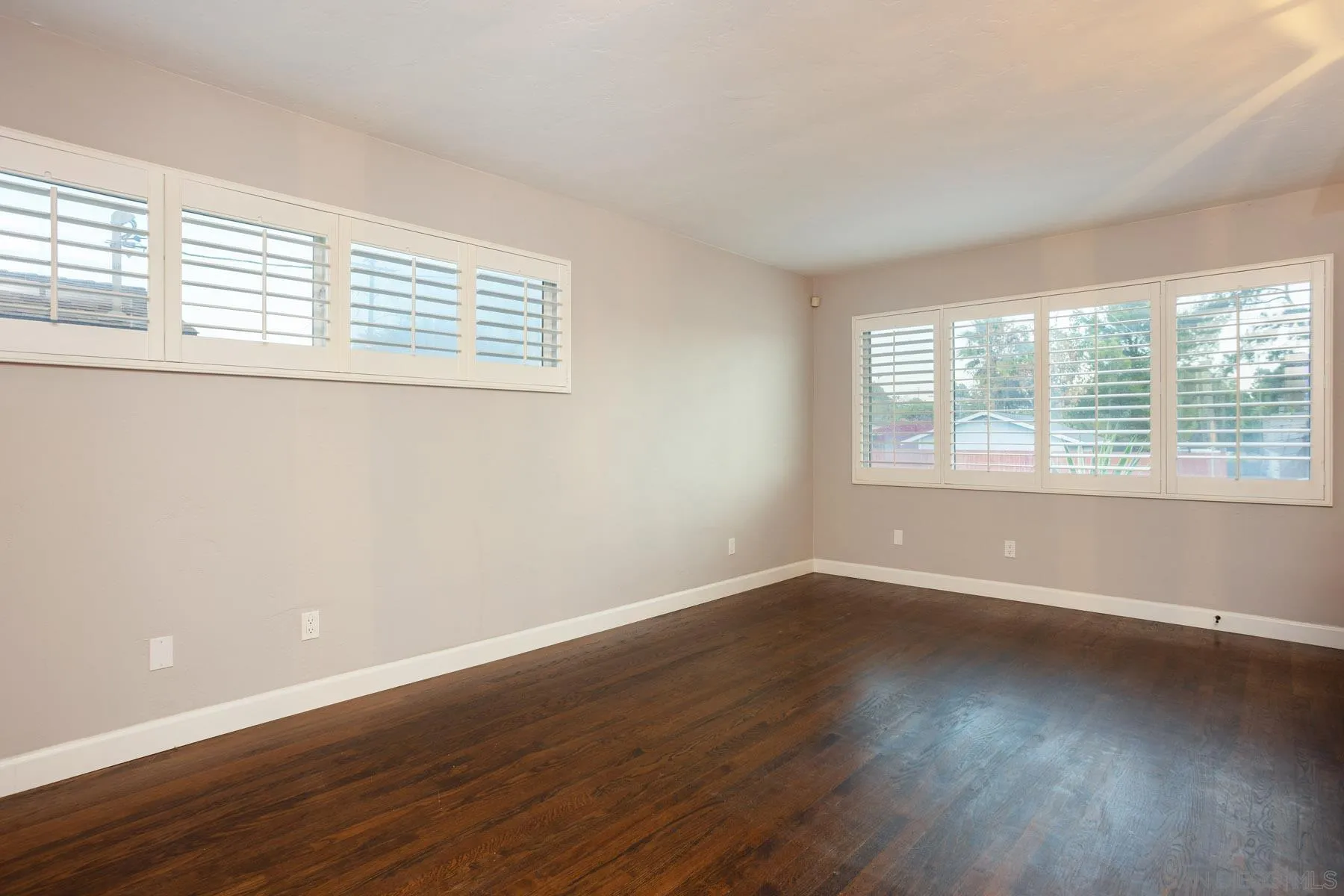 7354 Colony Road La Mesa, CA 91942 - Photo 9 of 24 a view of an empty room with wooden floor and a window