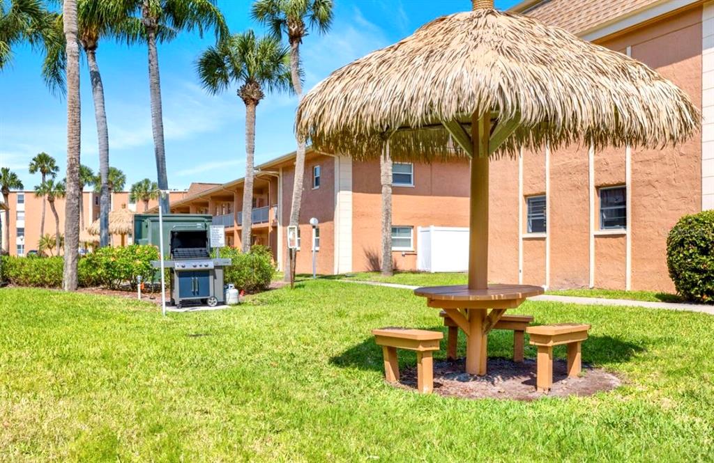 12760 Indian Rocks Road, Unit 903 Largo, FL 33774 - Photo 8 of 19 a backyard of a house with a garden and outdoor seating