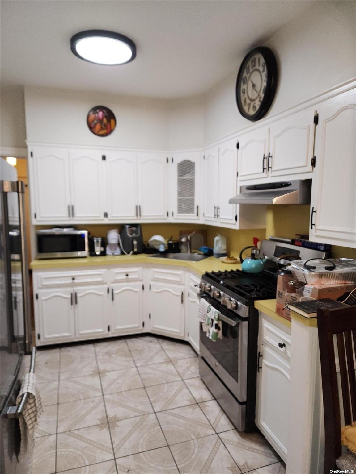 a kitchen with a stove oven and a sink