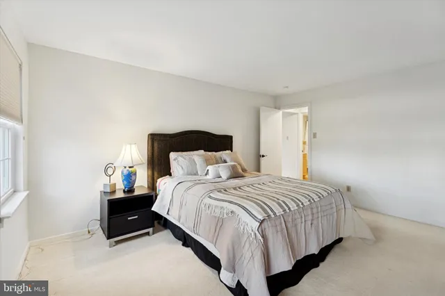 a bedroom with a bed and a potted plant