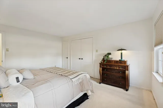 a bedroom with a bed and cabinets