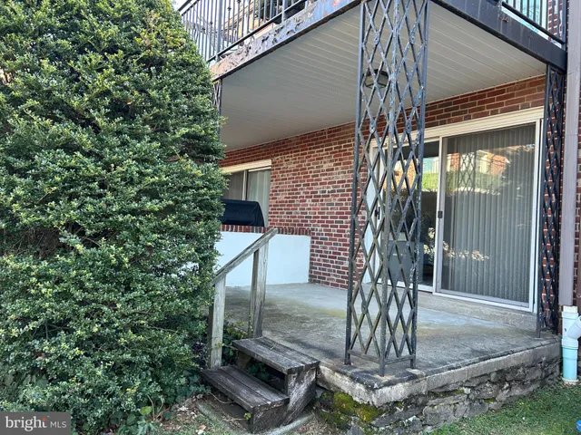 a front view of a house with a tree