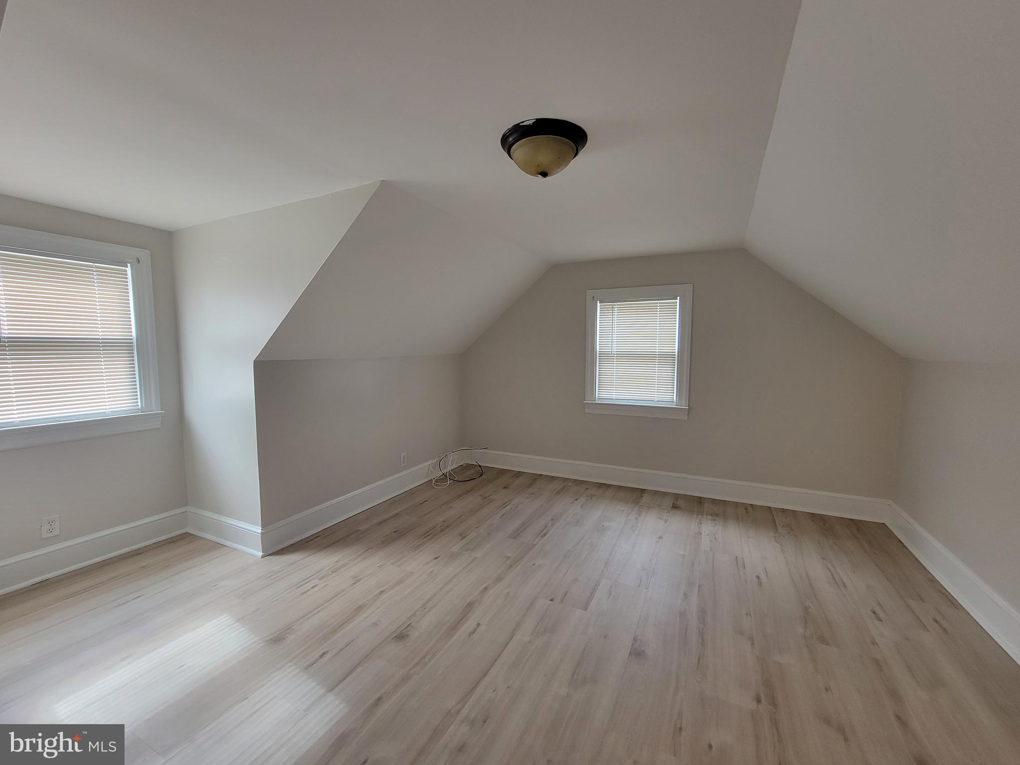 1111 Bayview Road Middletown, DE 19709 - Photo 12 of 15 an empty room with wooden floor and windows