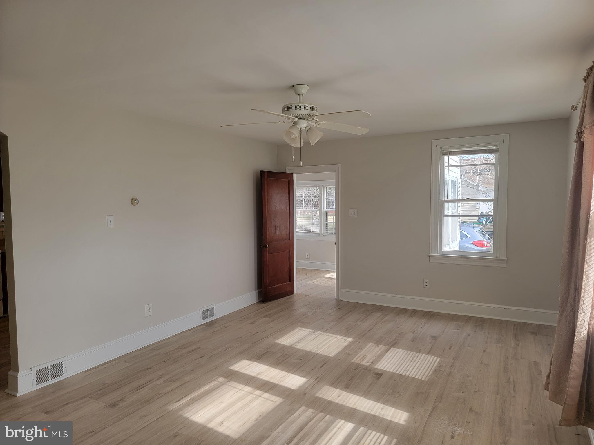 1111 Bayview Road Middletown, DE 19709 - Photo 14 of 15 an empty room with windows and ceiling fan