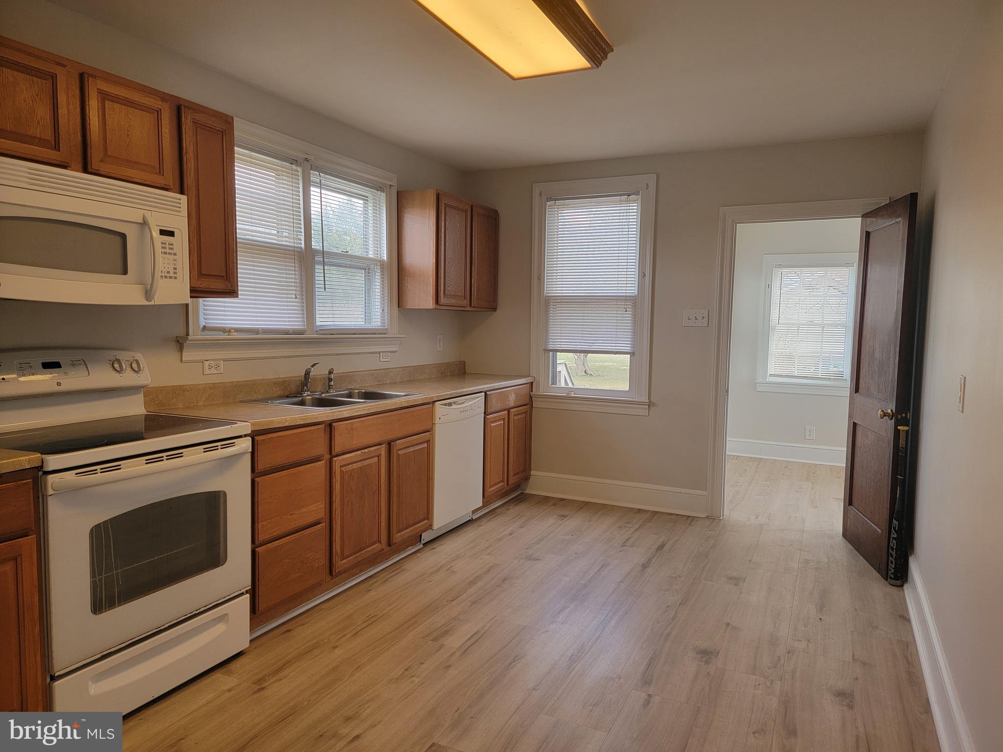 1111 Bayview Road Middletown, DE 19709 - Photo 3 of 15 a kitchen with a sink wooden floor and a stove