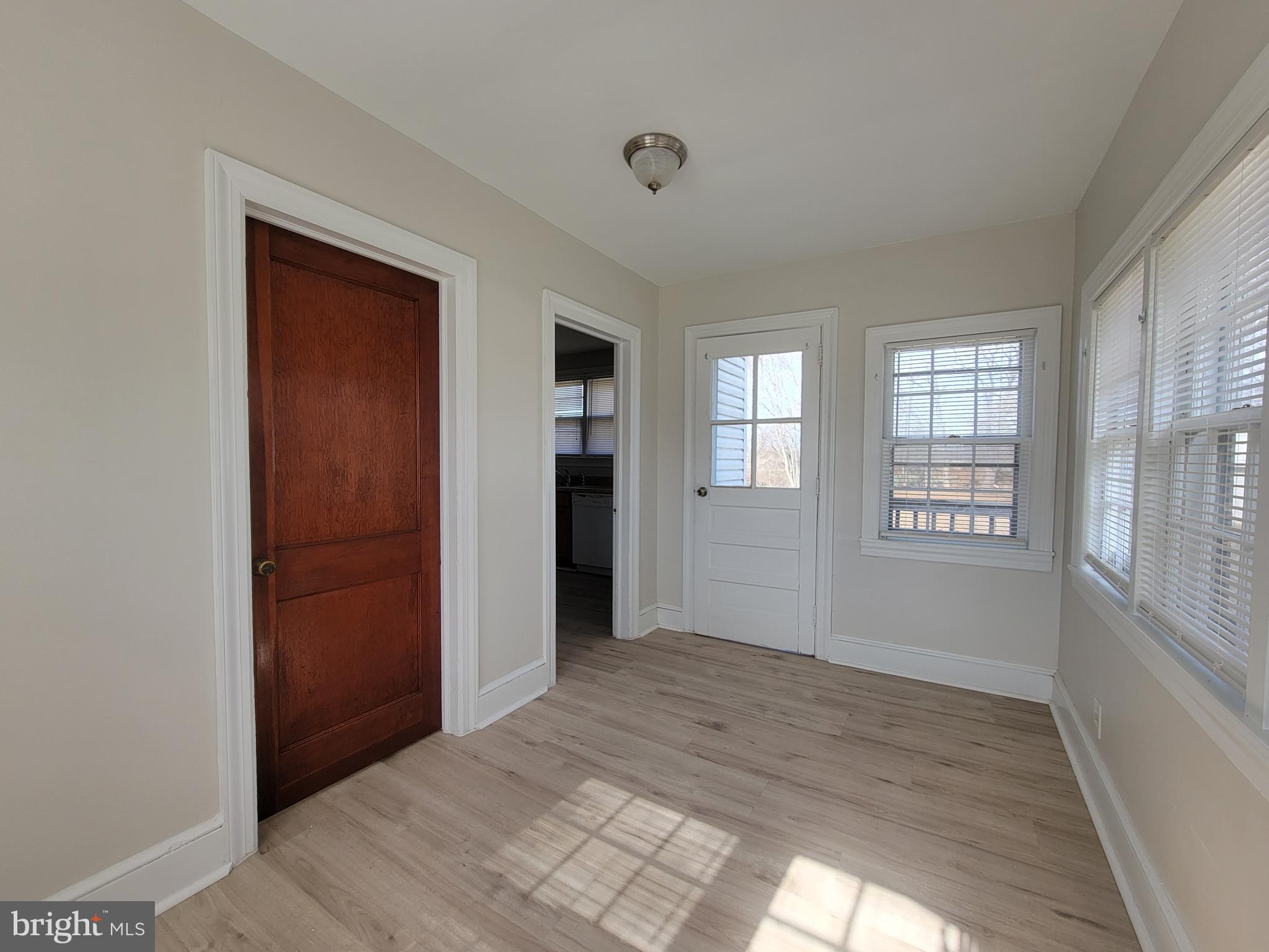 1111 Bayview Road Middletown, DE 19709 - Photo 4 of 15 a view of an empty room with wooden floor and a window
