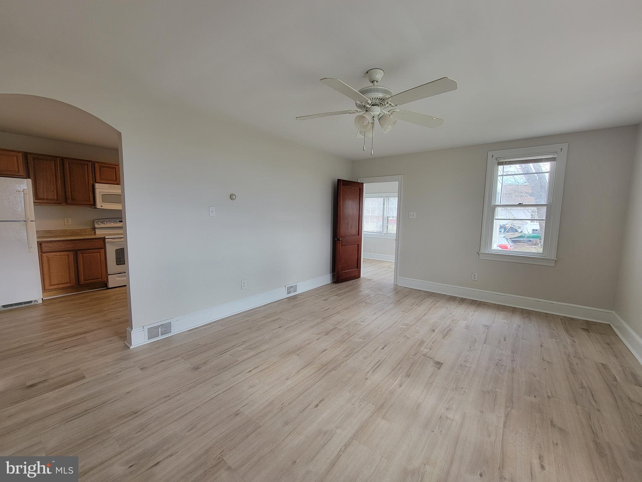 1111 Bayview Road Middletown, DE 19709 - Photo 9 of 15 a view of an empty room with a window and wooden floor