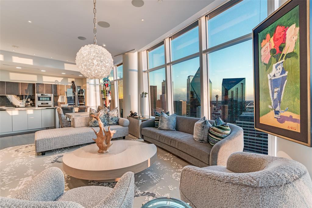 a living room with fireplace furniture and a large window
