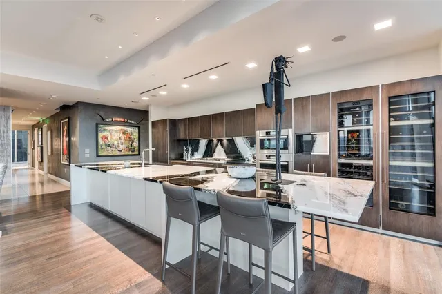 a large kitchen with a table and chairs