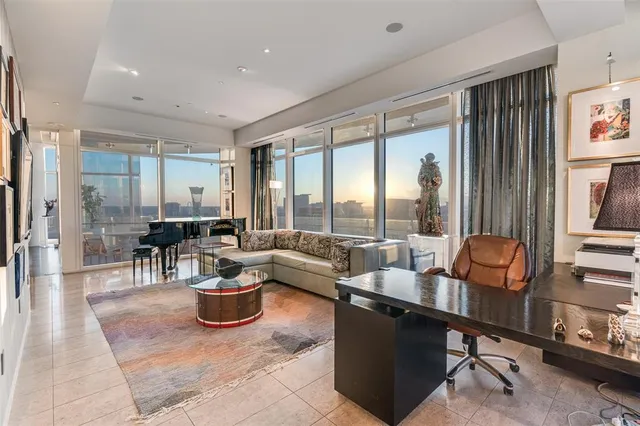 a living room with furniture a rug and a large window