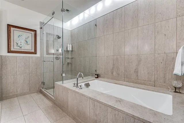 a spacious bathroom with a bathtub and shower
