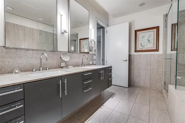 a spacious bathroom with a granite countertop sink a mirror and a