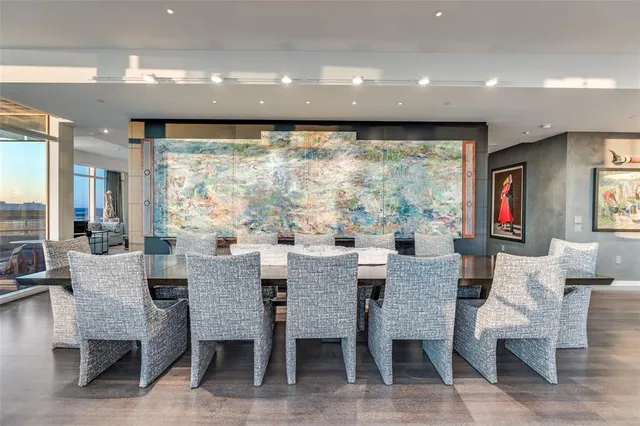 a dining room with furniture a large window and a projector