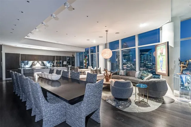 a living room with fireplace furniture and a large window