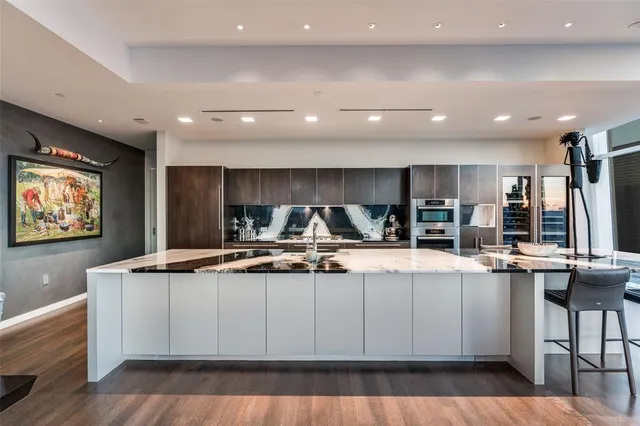 a kitchen with stainless steel appliances granite countertop a stove and a refrigerator