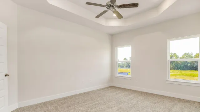 an empty room with windows and closet