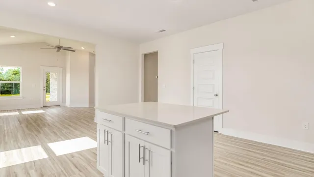 a kitchen with stainless steel appliances white cabinets and a sink